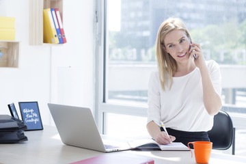 Beautiful young business woman in office