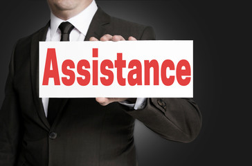 Assistance placard is held by businessman