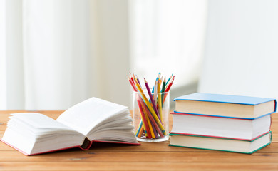 close up of crayons or color pencils and books