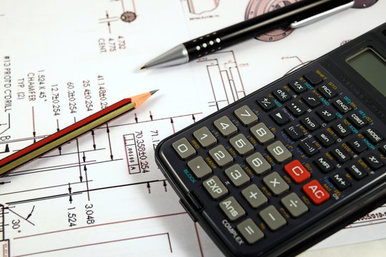 Eye Glasses, pen and pencil over the Formula with calculator