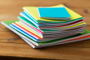 close up of notebooks on wooden table