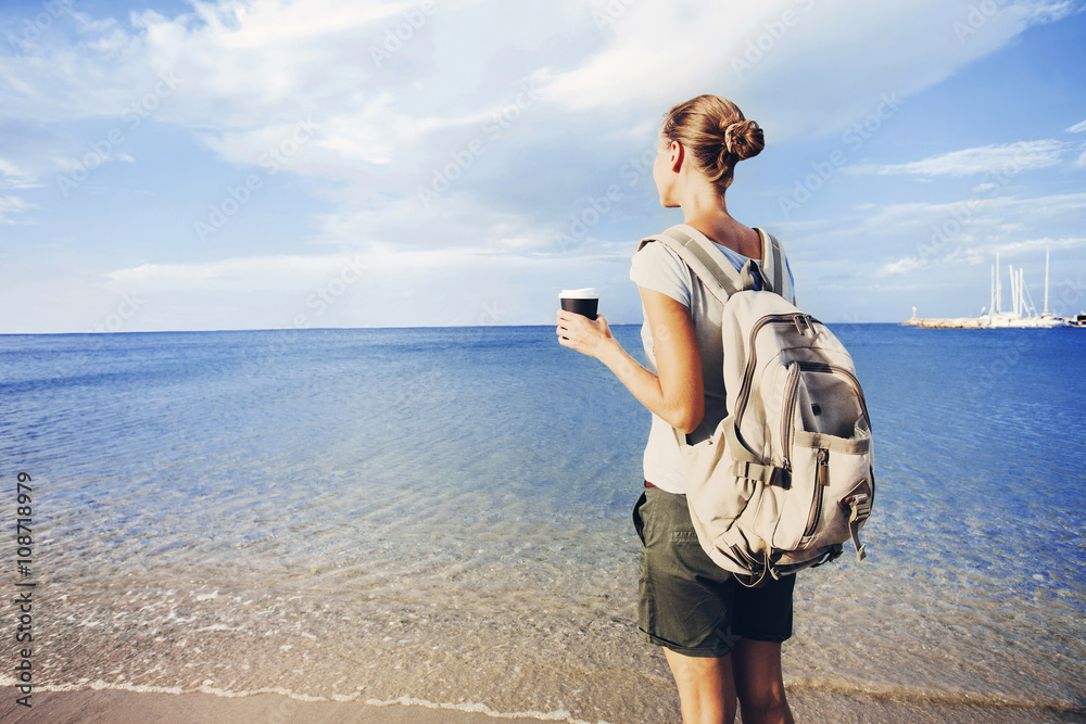 Wall mural back side of traveler girl looking at the sea, travel and active lifestyle concept