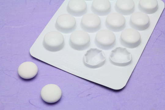 Two painkiller tablets from a blister pack