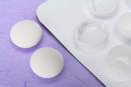 Two painkiller tablets from a blister pack - extreme close up