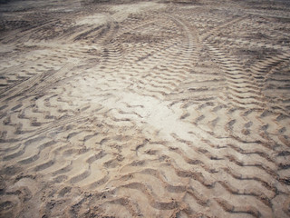 Wheel tracks on the soil.