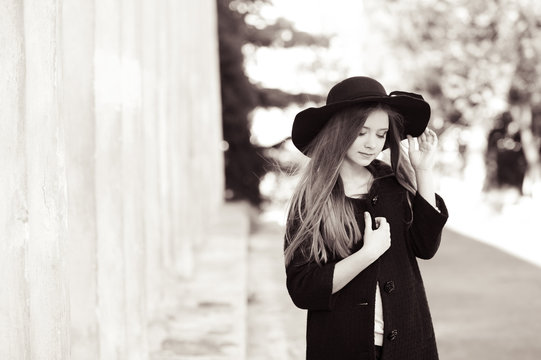 Beautiful teenage girl 14-15 year old wearing stylish winter coat and hat outdoors. Elegance. 