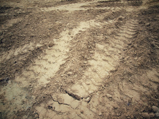 Wheel tracks on the soil.