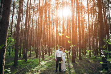 Wedding photosession of young couple near forest