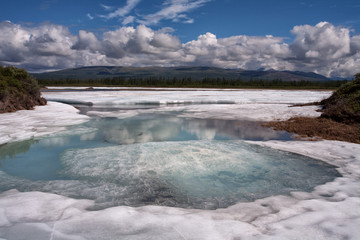 Remains of the ice in the river valley after the winter. Moma River. Yakutia. Russia.