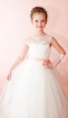 Adorable smiling little girl in white princess dress