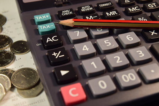 Pencil and Calculator with bill and coins