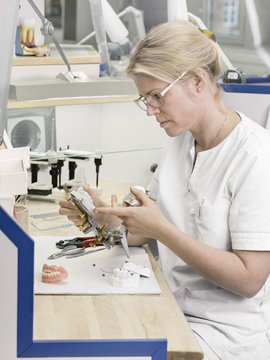 Dental technician making dentures