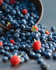 Bawl with fresh blueberries, blackberries and raspberries spilling