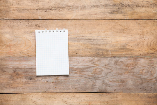 Blank notebook on wooden background. Copy space.