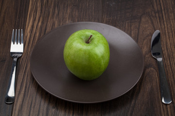 dieting and health food. Yellow, green apple on wood desk