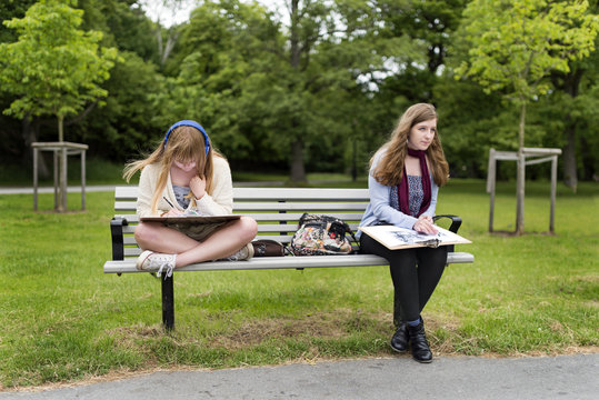 Teenage girls sitting on bench