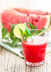 Watermelon juice with lime and mint in the glass 