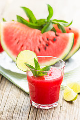 Watermelon juice with lime and mint in the glass 