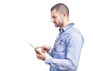 Side view of a handsome casual man using a digital tablet, isola