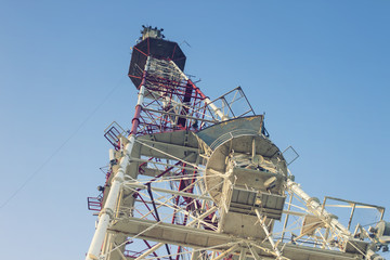 Telecommunications tower in a day of clear blue sky.