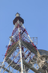 Telecommunications tower in a day of clear blue sky.