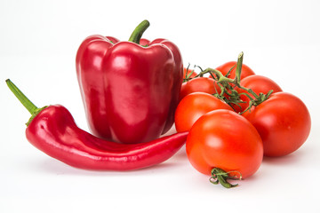 Two chili pepper and cherry tomatoes on stem top view isolated on white background