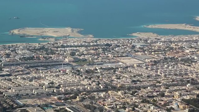 Panorama of residential district in Dubai and Persian Gulf, United Arab Emirates. View from the 124th floor of Burj Khalifa skyscraper in Dubai, currently the tallest structure in the world, 829,8 m