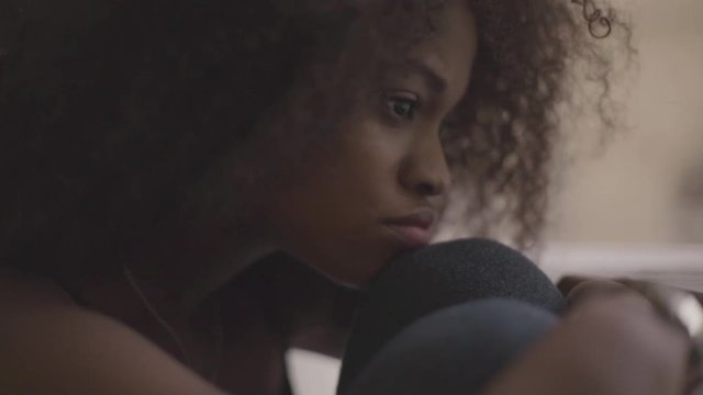 Close up of young beautiful black woman feeling very sad. Gorgeous girl in despair