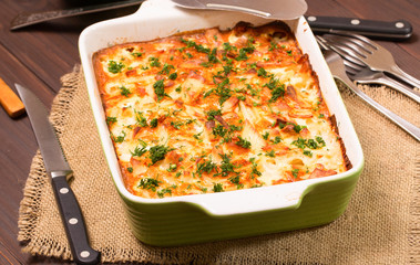 Dish with the baked potatoes on a kitchen table