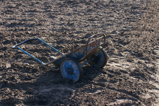 Old blue cart in the field. Agricultural works.