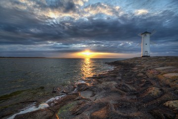 Fototapeta premium Lighthouse windmill Stawa Mlyny in Swinoujscie, Baltic Sea, Poland.