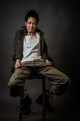 Androgynous character on a gray background. Man or woman. Military style. Very sharp.  