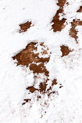 snow on red clay in nature