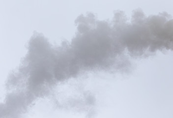 Smoke from a pipe on a cloudy sky