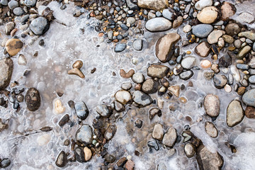 Stones in the ice on the nature