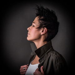 Androgynous character on a gray background. Man or woman. Military style. 