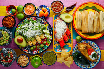 Fototapeta na wymiar Green and red enchiladas with mexican sauces