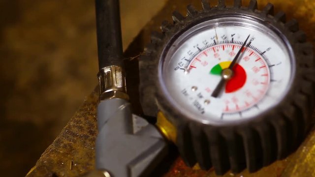 Color video of a tire pressure gauge inflating a tire.