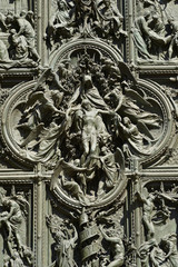 Fototapeta na wymiar Bronze door of the Milan cathedral detail