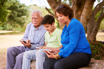 Child Helping Grandparents Going Internet On Phone
