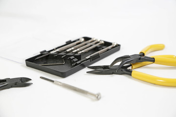 Pliers and screwdriver on white background