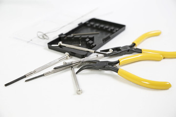 Pliers and screwdriver on white background