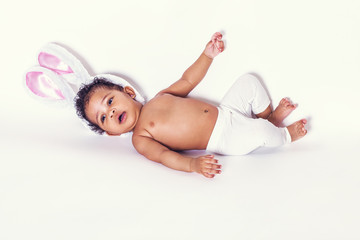Obraz na płótnie Canvas Lovely baby girl portrait lying and wearing bunny ears