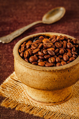 Coffee beans in a vintage bowl, close up