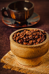 Coffee beans in a vintage bowl, close up