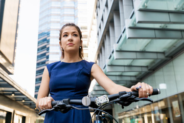 Naklejka na ściany i meble Young woman commuting on bicycle