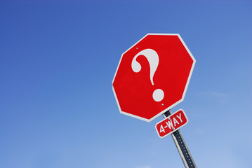 question mark on stop sign against sky