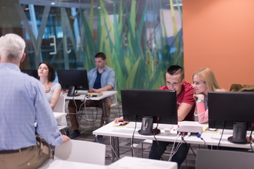 teacher and students in computer lab classroom