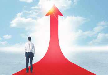 businessman standing on a red arrow