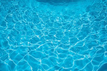 Fototapeta na wymiar Pattern of ripple wave with sun reflection in swimming pool